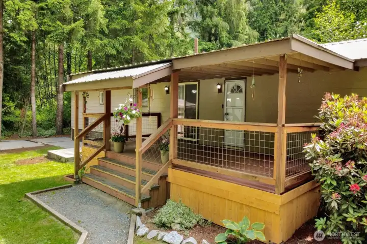 Covered front porch overlooking the beautifully landscaped yard