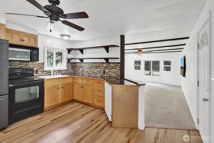 Kitchen design offers generous work areas, abundant storage, and easy access to adjoiningliving spaces.