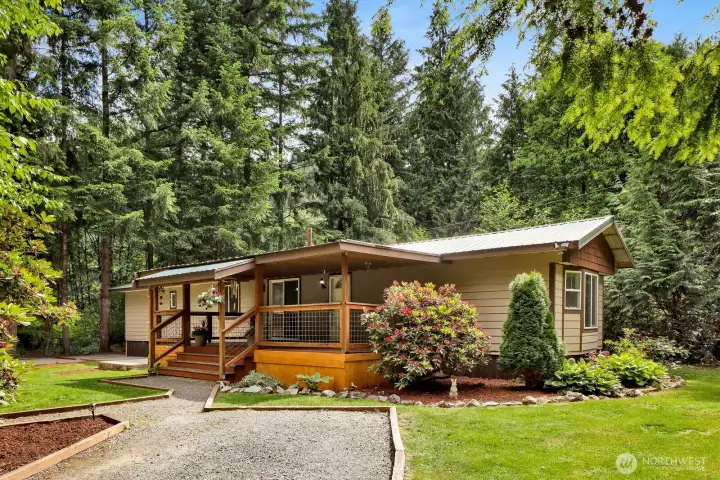 Front exterior framed by mature landscaping and established trees.