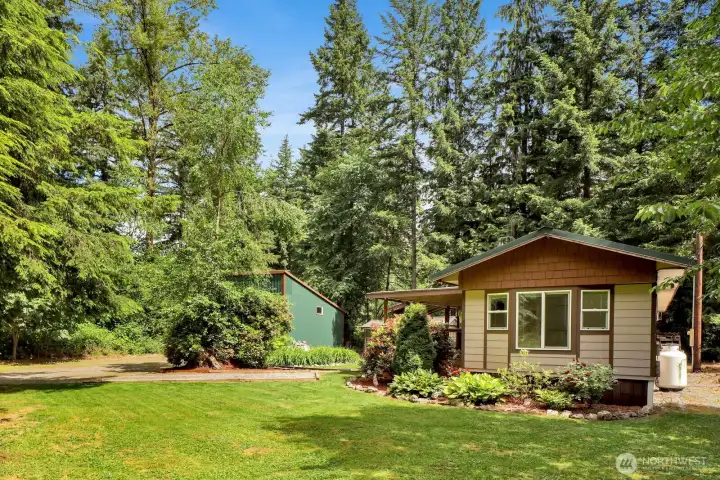Front yard view showcasing the home's peaceful setting and mature landscaping.
