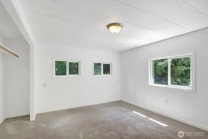 Spacious primary bedroom with flexible layout options and ample wall space.