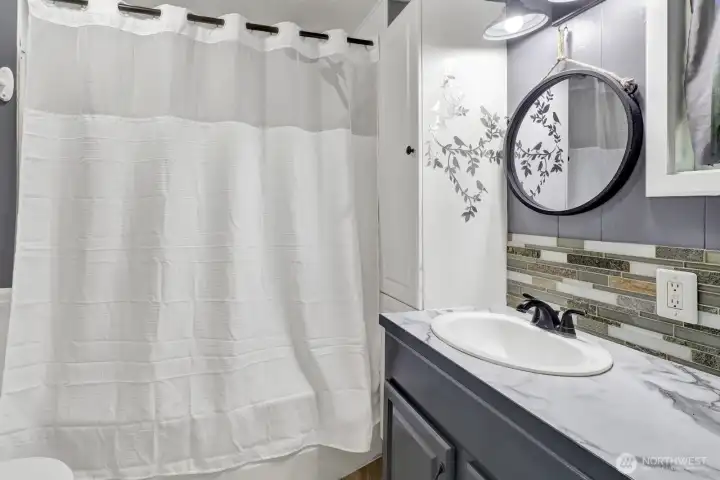 The bathroom is accessible to the primary bedroom as well as the hallway for guest use. Tub/shower combo.