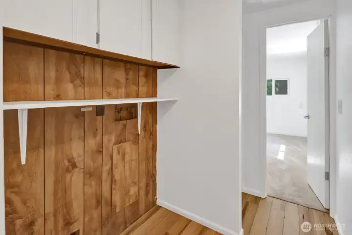 Laundry and utility area with additional storage.