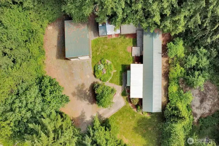 Overhead aerial view illustrating the layout of the home, shop, driveway, and outdoor spaces.
