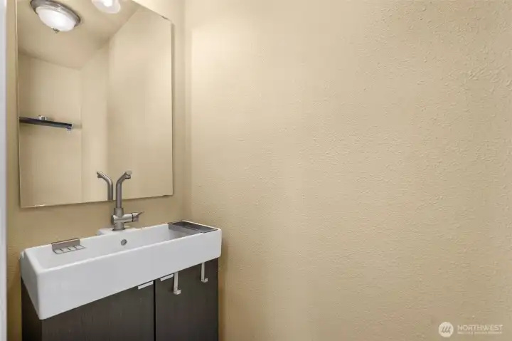 Primary Bedroom - 1/2 Bathroom with a Sink and Toilet