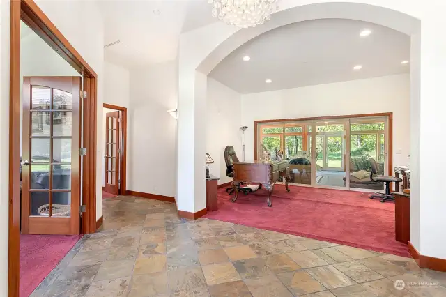 A grand entrance into this home opens up to views of dining, library, and office. Off in the distance is the enclosed patio that was converted into a sun room.