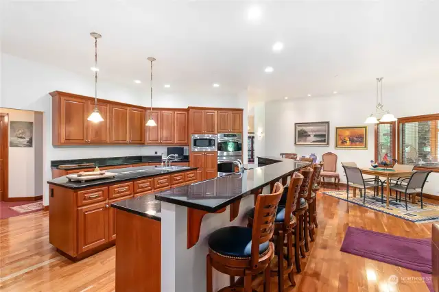 Off in the distance of this kitchen view is another great eating space for your large crowd. Did I mention this kitchen was designed with entertainment in mind?!