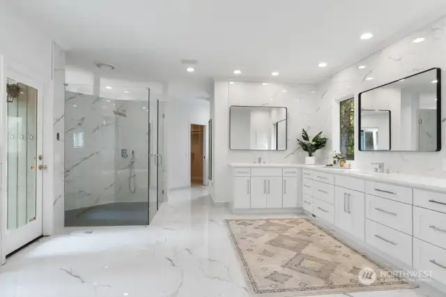 The enormous newly updated bathroom features heated designer tiled floor, free standing soaking tub, new vanity with quartz counters and 2 walk-in closets.