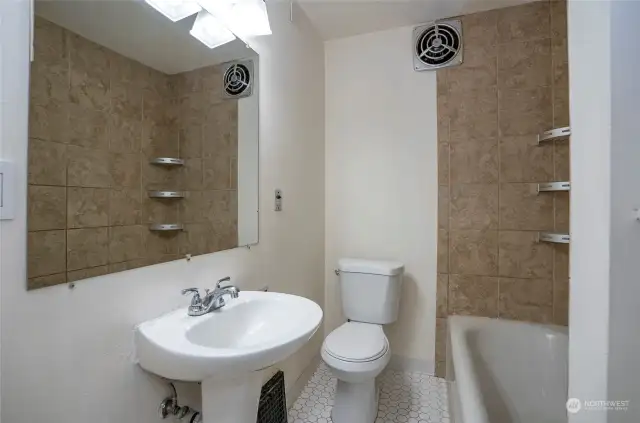 Main floor bathroom with tub and shower