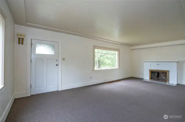 Entering the front door is this large living room with woodburning fireplace