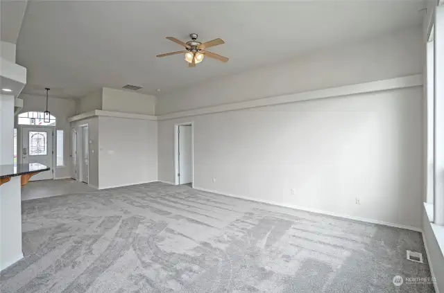 Here’s another angle of the living area, with the doorway leading to the primary suite conveniently located to the right.