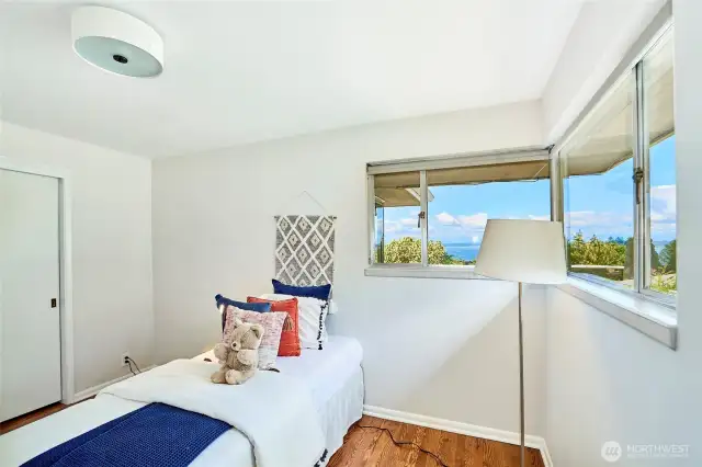 Second bedroom on main floor with corner windows and views.