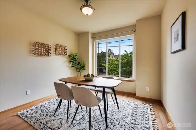 Large dining room with large oversize window allowing the beauty of the outdoors in