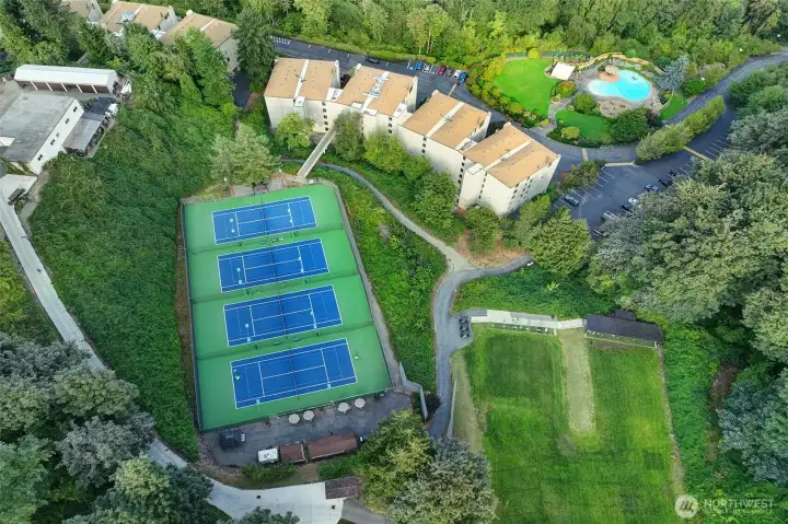 Residents can enjoy the use of the driving range (pictured on the right) or make a reservation to play tennis. Bridge to tennis courts are accessed from Building A where this unit is.