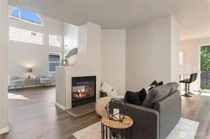 A spacious family room is situated on the opposite side of the fireplace.