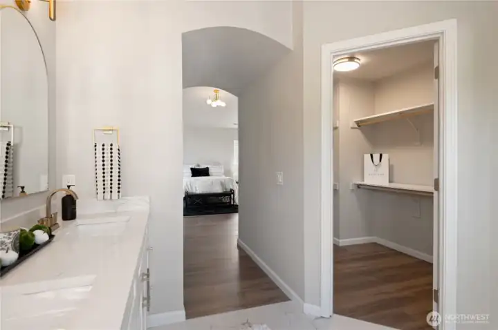 A spacious walk-in closet is featured within the primary suite, offering ample storage and organization options.