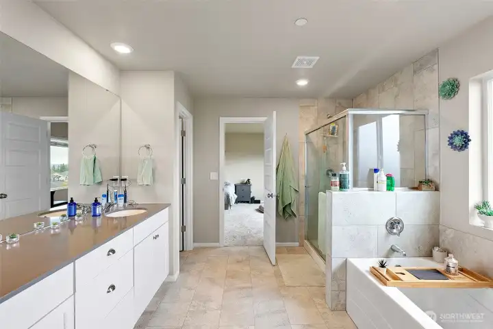 Primary ensuite bath with class shower and soaking tub