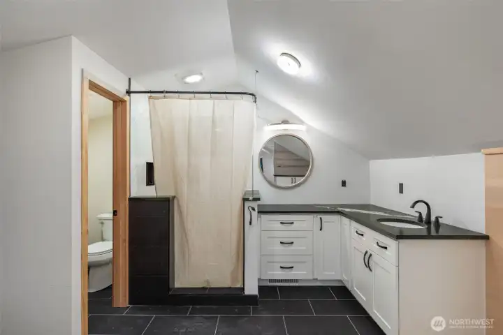 Primary Suite, Recently remodeled with contemporary shower and lush green serpentine counters