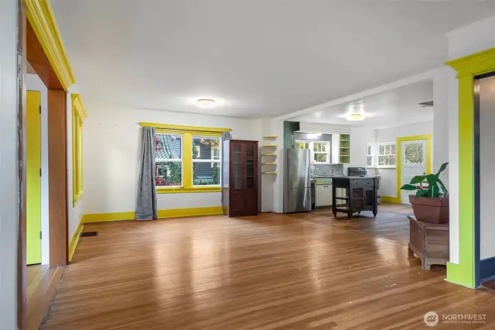Main level: AS-IS. Existing open space, for flexible living or dining. Main entry to the left, kitchen to the right