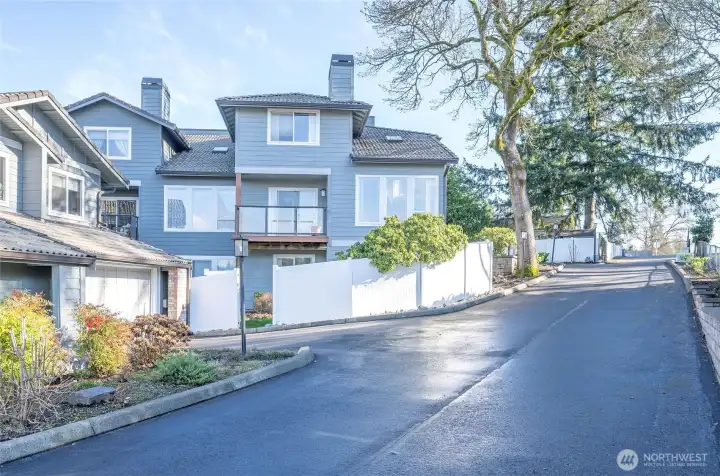 Attractive rear view of the end-unit condo with a private, fenced yard.