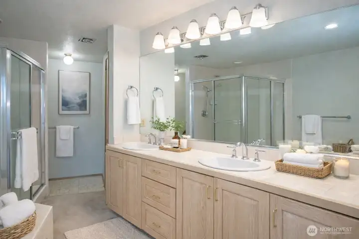 Primary ensuite featuring dual sinks, with a spacious walk-in closet conveniently located just around the corner.
