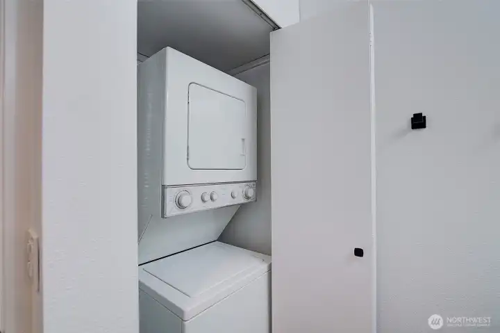Stackable washer and dryer in the unit.