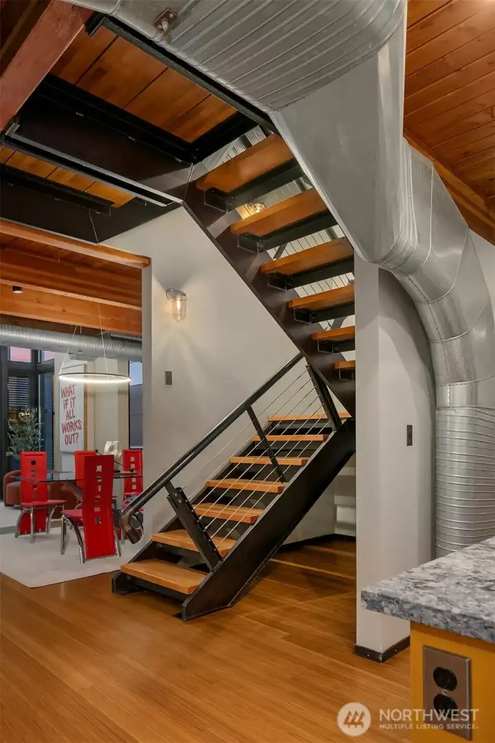 Stairs to loft level primary suite + second bedroom suite.