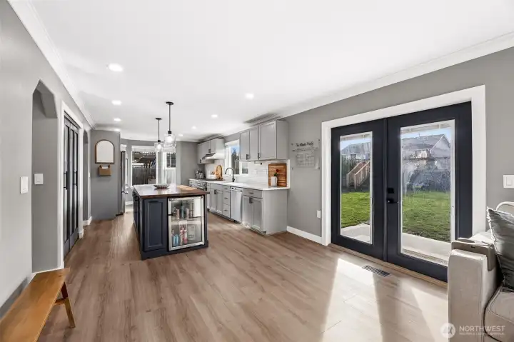 French doors lead off the kitchen/family room area out to an entertainer's dream backyard.