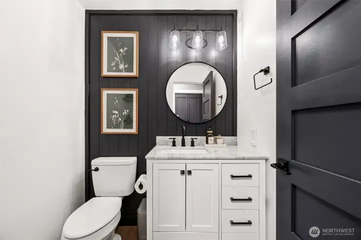 Stylish main floor powder room with beadboard accent wall.