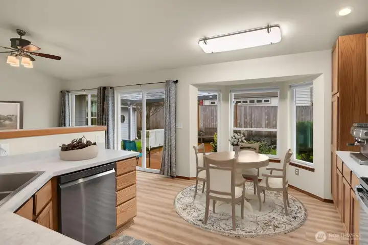 Kitchen view to the Eating Nook & Slider to the Covered Patio - Virtually Staged
