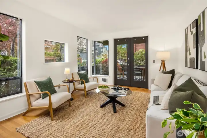 Generous living room with lots of light while maintaining privacy, and French doors that open to the larger of two patios.