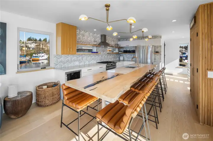 Open-concept kitchen & living space anchored by a striking oversized custom live-edge oak island.
