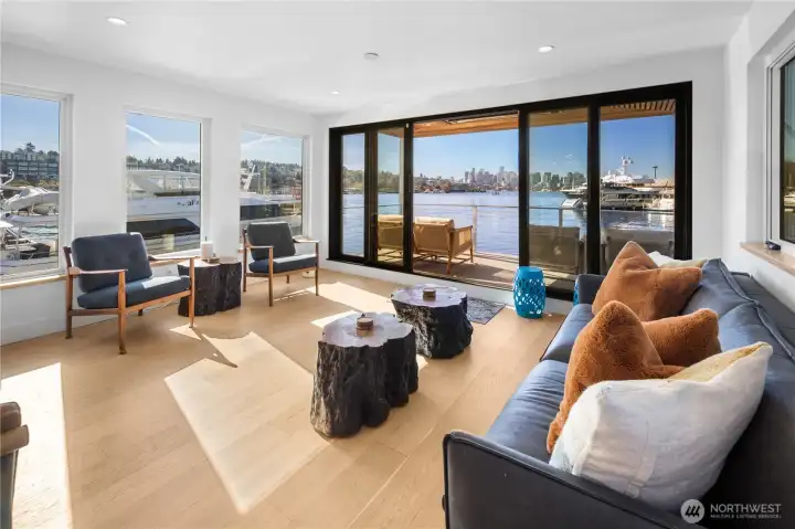 Expansive wall sliders fully open to a heated view deck with stunning, unobstructed city & lake vistas.