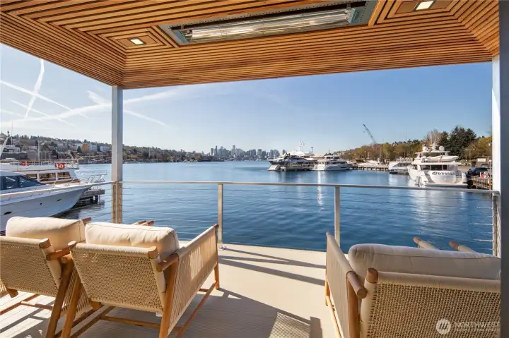 Expansive wall sliders fully open to a heated view deck with stunning, unobstructed city & lake vistas.