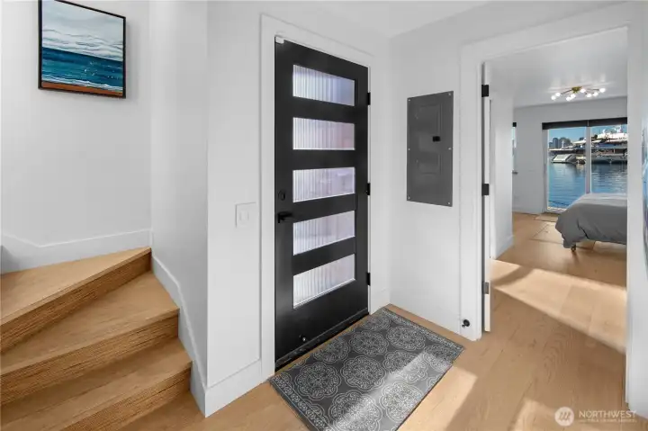 A thoughtfully designed layout features a private primary suite on the main level with a lux bath and sliding doors opening to the deck—perfect for a morning dip, paddle board or coffee and croissant over the water. The entry level includes an additional bedroom & second lux bath, ideal for guests or flexible living.