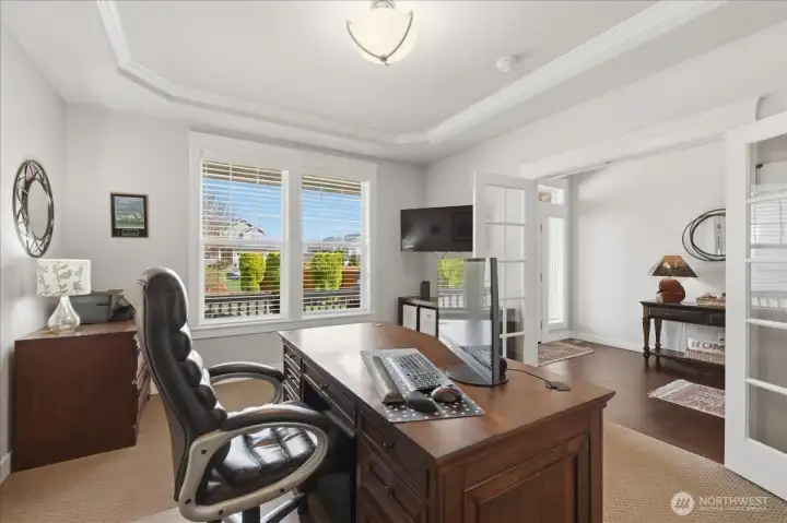 Private den with storage closet and pretty glass-front French doors. South facing views provide natural light throughout the day.