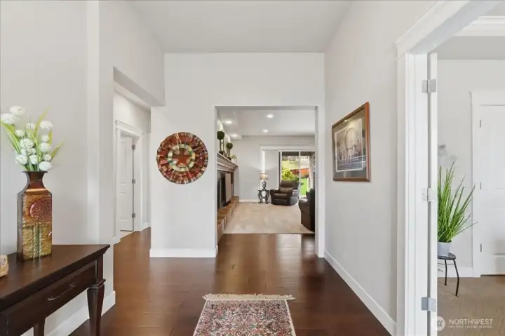 To the left of the foyer are bedrooms 2 and 3 a main bathroom. The engineered hardwoods continue down the bedroom wing hallway.