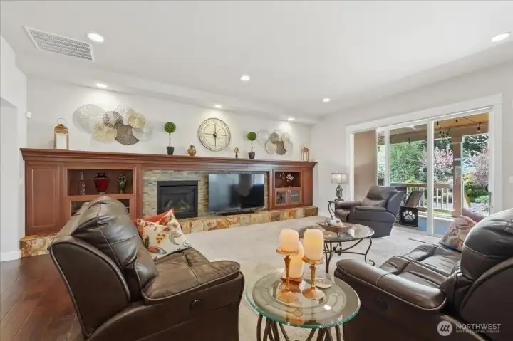 This fireplace wall - 21 1/2 feet of beauty!  With built-in open shelving, glass-front and hidden storage, mantle and slate-tiled hearth. This is the perfect spot to display treasured items and/or holiday decor.