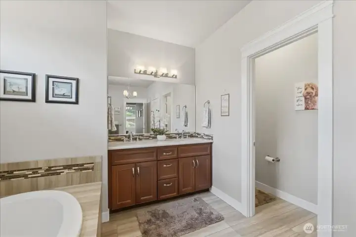 Primary bathroom with 6 foot vanity with dual undermount sinks. Separate water closet.