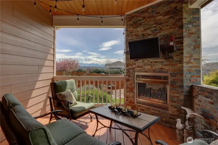A closer look at the gas fireplace and the beautiful mountain view! All outdoor furniture is negotiable.