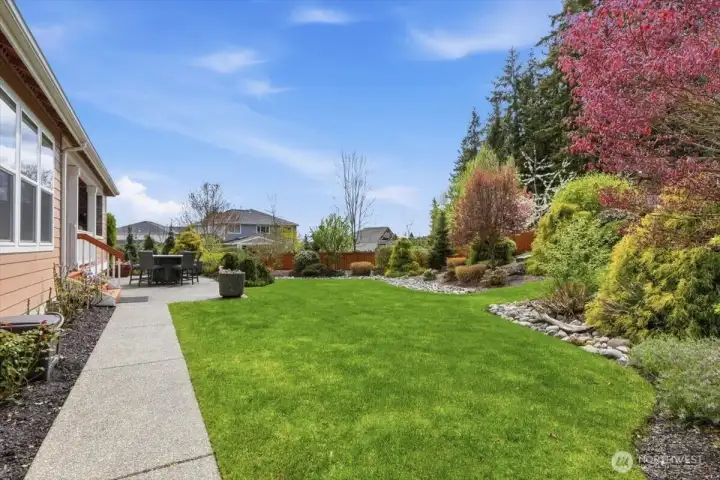 Sidewalk extends along the back exterior.  16 rose bushes along home and walkway.