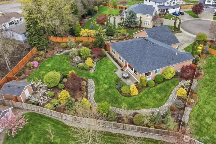 The backyard is fully-fenced, puppy-proofed, and gated. Also notice the additional fenced area providing extra storage behind the large shed in lower left corner.