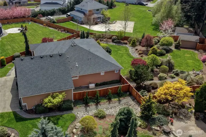Behind the garage and side of the home is fully fenced storage for your waste bins. The access from this area to the garage is a roll-up door ideal for your zero-turn mower or UTV.  This is also where the whole-house automatic transfer generator is.
