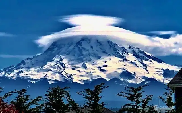 Snowcapped mountain view on a clear Winter day wearing her lenticular bonnet
