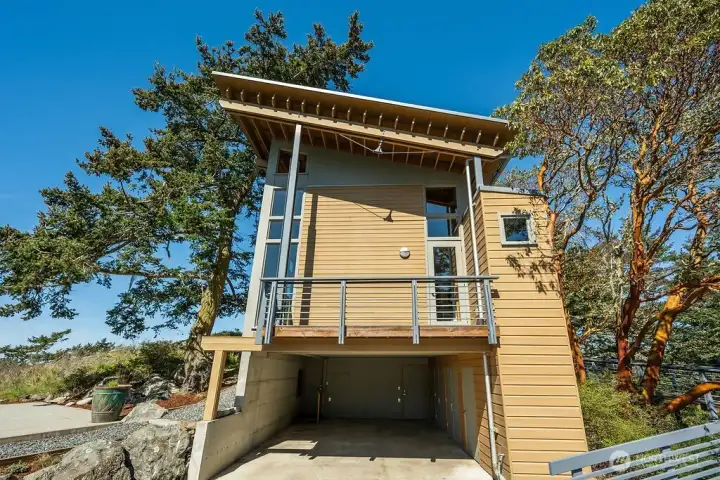 Carport, with a mechanical room/work area and ample storage closets on the right.