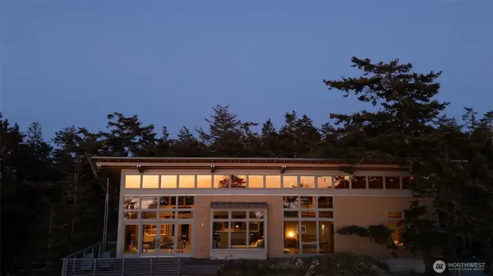 The sunset reflected in the wall of windows.