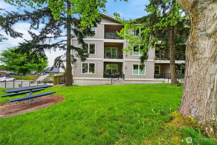 Side view of the condo building from the park grounds, unit is the top floor, left balcony.
