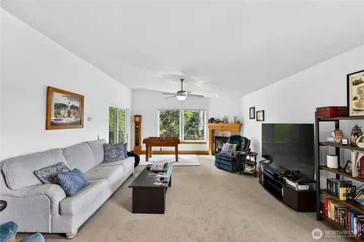 Living room is light and bright and looks out of the park.