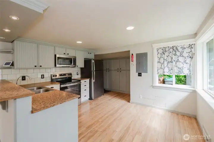 Roomy kitchen space with stairwell down to the primary suite.