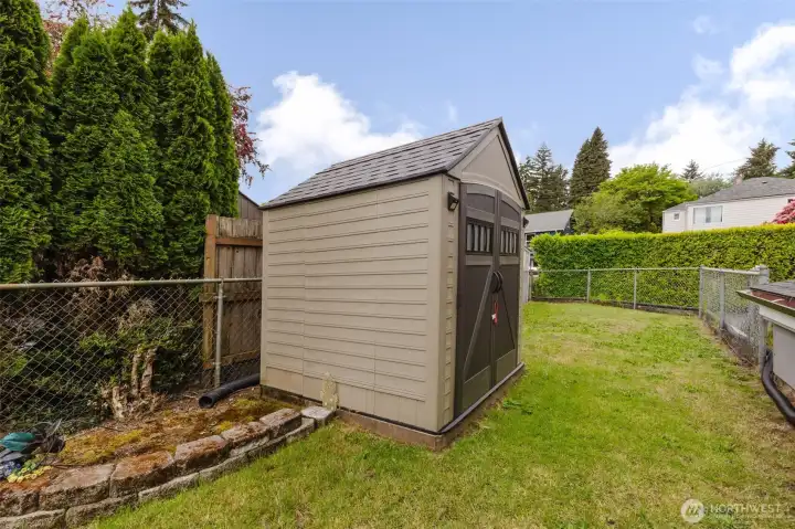 Storage shed and fenced side yard.